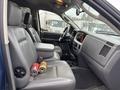 Interior of a 2006 Dodge Ram 2500 showing front seats and dashboard with a console and items on the seat