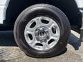 A close-up of a wheel and tire from a 2023 Ford F-350 SD featuring a six-spoke alloy rim and a rugged General tire