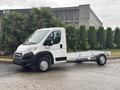 A 2023 RAM Promaster 3500 chassis cab with a white exterior and empty bed designed for commercial use