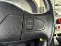 Close-up of the steering wheel with a black textured grip featuring controls for cruise settings including buttons labeled Set, Resume, and Accel