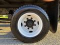 A close-up of a black tire mounted on a white wheel with a central hub, labeled Goodyear, from a 2018 Hino 268 truck