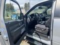 A 2014 Ford F-150 with an open driver's door revealing the interior including seats and dashboard