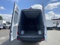 Interior view of a 2025 Mercedes-Benz Sprinter cargo van with open rear doors showing a spacious empty loading area