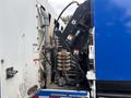 Close-up of the hydraulic system and controls of a 2013 International DuraStar 4300 with various hoses and fittings visible