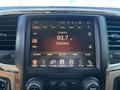 A touchscreen display in a 2015 RAM 1500 showing radio station information for 93.7 FM with country music details and various options for controls and settings
