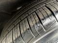Close-up of a tire from a 2023 Alfa Romeo Giulia showing tread pattern and wear with some dust on the surface
