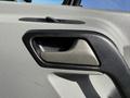 Interior door handle of a 2016 Mercedes-Benz Sprinter with a black frame and textured grip