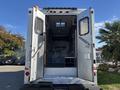 A 2008 International 4400 truck with open rear doors revealing interior compartments and equipment