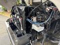 A 2020 Freightliner MT45 engine with visible cooling components hoses and electrical connections in the foreground