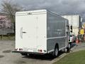 A white 2017 Freightliner MT45 step van with a boxy design and rear cargo doors parked in a lot