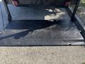 A black diamond plate loading ramp is extended from the back of a 2014 RAM 5500 truck