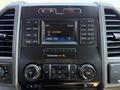 The image shows the dashboard of a 2018 Ford F-550 with a touchscreen display and various control buttons for audio and climate settings