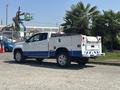 A 2017 Chevrolet Colorado with a white and blue exterior featuring a utility bed and chrome wheels parked in a lot