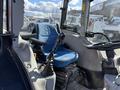 Interior view of a 2010 New Holland T4050 tractor showing the blue driver's seat and gear shift control