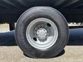 A close-up view of a Bridgestone tire mounted on a 2020 Hino 338 truck showcasing the rim and lug nut design