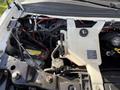 The image shows the engine compartment of a 2017 Chevrolet Express with various components including a battery coolant reservoir and numerous electrical connections and hoses