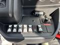 Control panel of a 2018 Ford Transit-350 featuring various buttons and switches for lights and other vehicle functions