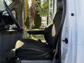 A 2015 Ford Econoline driver's seat in black fabric with a visible seatbelt and armrest