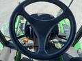 The image shows the steering wheel and dashboard of a 2016 John Deere 1585 Terrain Cut mower with controls and a gearshift lever visible