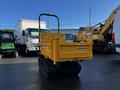 A yellow 2013 Yanmar C12R-B mini dumper with a flatbed and tracks positioned for transportation or loading materials