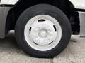 A close-up of a white rim and tire on a 2012 International TerraStar showing the tread and bolts on the rim