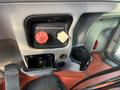 Interior dashboard controls of a 2009 Peterbilt Highway including a red parking brake switch and a cup holder