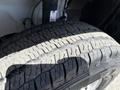 A close-up of a worn tire from a 2021 RAM Promaster showing significant tread wear and uneven surface patterns
