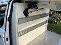 Interior of a 2019 Ford Transit Connect showing a white wall with metal slats and hooks for securing cargo