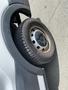A close-up of a wheel from a 2019 Ford Transit showing the tire and rim with visible tread patterns and a metallic hubcap