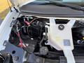 Engine compartment of a 2017 Chevrolet Express showing the engine battery cooling system and various components including hoses and reservoirs