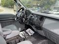 Interior of a 2018 Ford F-750 featuring a gray driver's seat dashboard with audio controls and a steering wheel visible