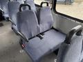 Interior seating of a 2018 Chevrolet Express with two fabric-covered seats featuring seatbelts and armrests