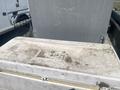 A 2010 Aluminum 16 foot boat with a weathered surface and some signs of wear located in a boat storage area