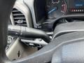 Close-up of the steering column of a 2017 Ford F-250 SD showing the gear shift lever and dashboard instrument panel