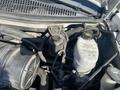 Engine components of a 2011 Chevrolet Express including a black air intake and a translucent coolant reservoir