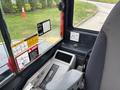 Interior view of a 2017 John Deere 50G excavator showing control panel and safety labels