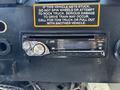A JVC car stereo with a digital display and multiple buttons in a vehicle dashboard