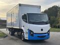 A 2022 Lion Lion6 electric truck with a white and blue color scheme is shown facing forward featuring a modern design with a prominent front grille and large windshield