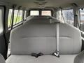 Interior seats of a 2013 Ford E-350 van with grey upholstery and seatbelts visible on each seat