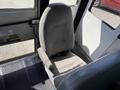 Interior view of a 2011 Freightliner B2 bus showcasing a single gray fabric driver's seat with a seatbelt