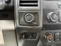 The image shows the control panel of a 2019 Ford F-350 SD featuring a four-wheel drive selector knob along with various buttons for volume and climate control