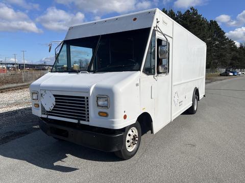 White 2012 Ford Econoline delivery truck with a boxy shape and front grille displaying large headlights and a hood ornament