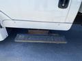 A 2014 International TerraStar truck with a sturdy metal step and a compartment beneath it