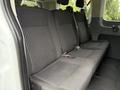 The image shows the backseat of a 2017 Ford Transit T150 XLT featuring three upholstered seats with a striped pattern and seatbelts