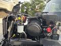 A 2013 International WorkStar truck with its engine compartment open displaying the engine components including the air filter coolant reservoir and various wires and hoses