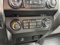 Close-up of the climate control panel in a 2020 Ford F-550 featuring buttons for fan speed temperature settings and air conditioning controls