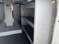 A 2019 Ford Transit 350 interior featuring metal shelving units designed for storage and organization
