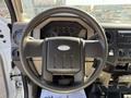 A steering wheel of a 2008 Ford F-450 SD with dashboard controls and gauges visible in the background