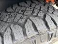 Close-up of a rugged tire tread on a 2019 Ford F-150 showcasing deep grooves and a durable design for off-road traction