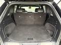 The cargo area of a 2019 Jeep Grand Cherokee shows a spacious, flat surface with foldable rear seats covered in dark fabric